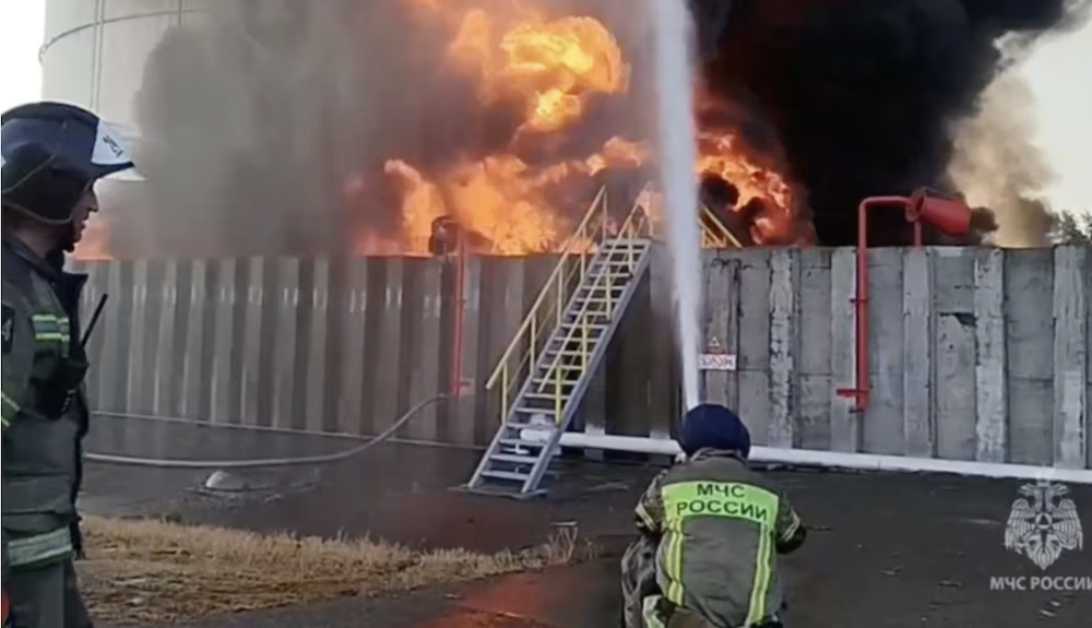 Members of the Russian emergencies ministry work to extinguish fire at an oil storage tank after an alleged drone attack in the town of Azov in the southern region of Rostov, Russia, June 18, 2024, in this still image taken from video. (Reuters/Handout/Russian Emergencies Ministry)