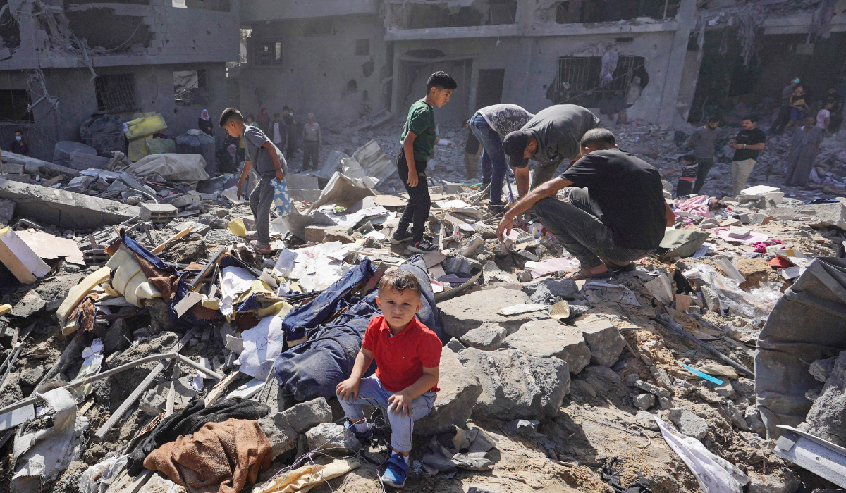 Palestinian residents search the rubble of a family home destroyed in Israeli strikes in the central Gaza Strip on Tuesday. (AFP)