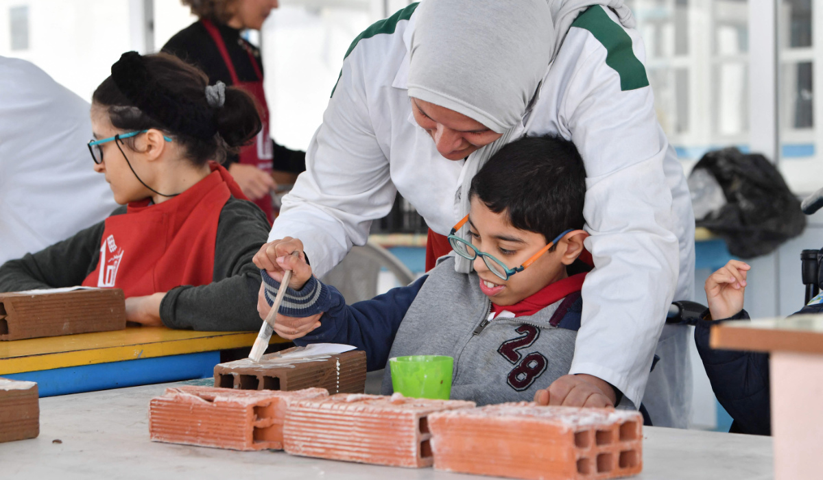 A group of young people with disabilities participate in the creation of a collaborative work of art at an institute that offers educational, artistic and social programs in La Marsa, a suburb of Tunis, on February 22, 2024. (AFP)