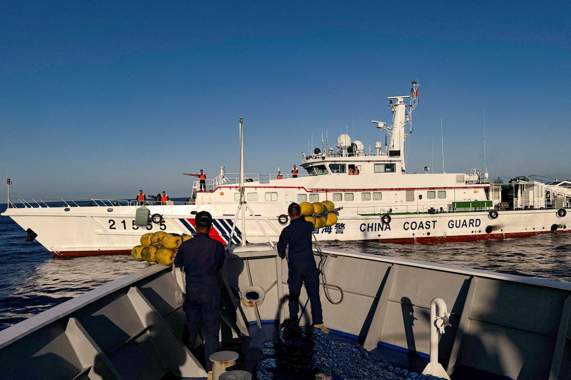 Philippine Coast Guard personnel prepare rubber fenders after Chinese Coast Guard vessels blocked their way to a resupply mission at the Second Thomas Shoal in the South China Sea on March 5, 2024. (Reuters)