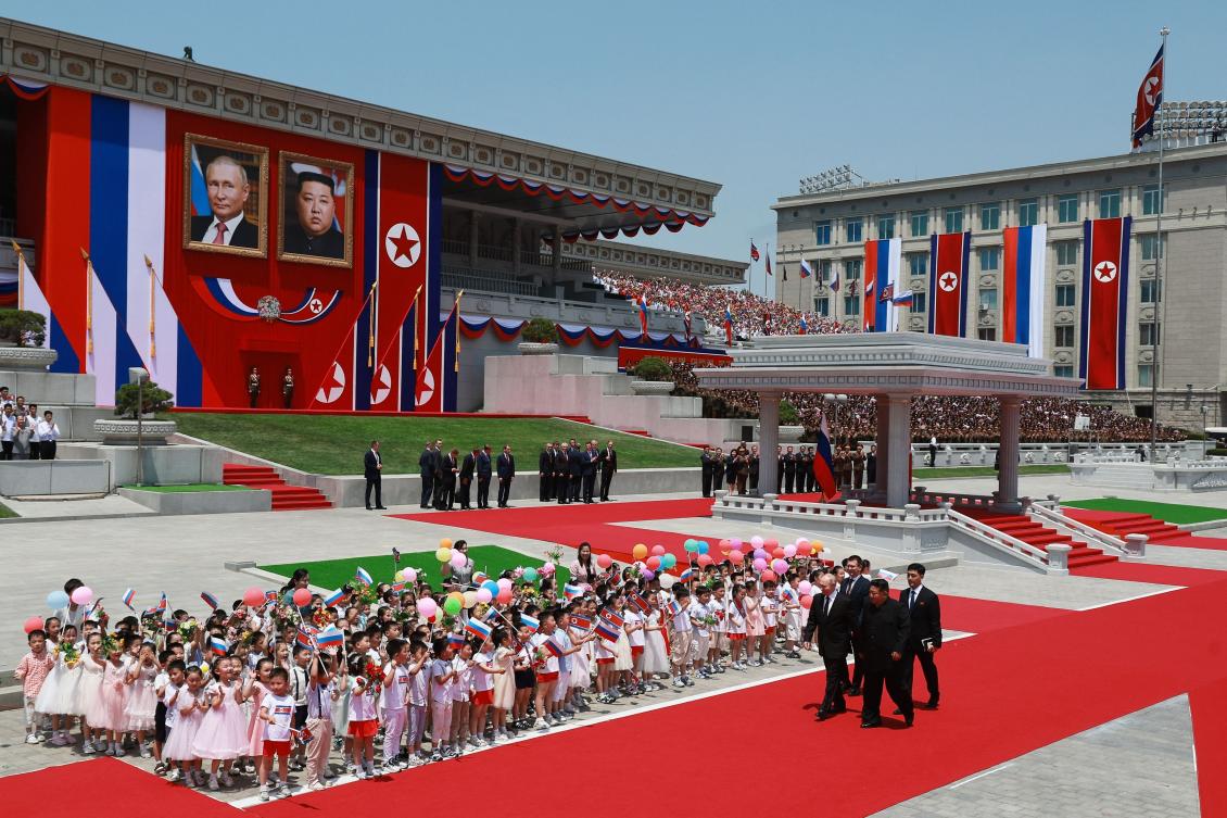 North Korean leader Kim Jong Un, center right, and Russian President Vladimir Putin, left, attend a welcoming ceremony at Kim Il Sung Square in Pyongyang on June 19, 2024. (Sputnik/AFP)