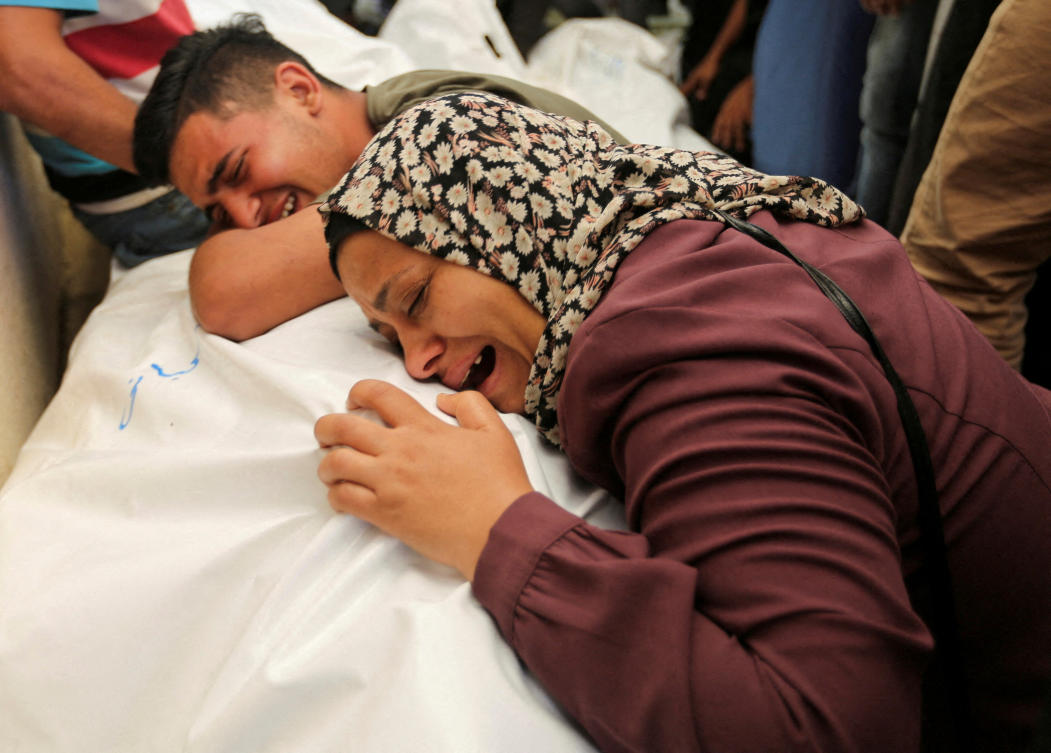 Mourners react next to the bodies of Palestinians, killed in Israeli strikes due to a military operation in Rafah, amid the Israel-Hamas conflict, during their funeral in Khan Younis, in the southern Gaza Strip, June 18, 2024. (REUTERS)
