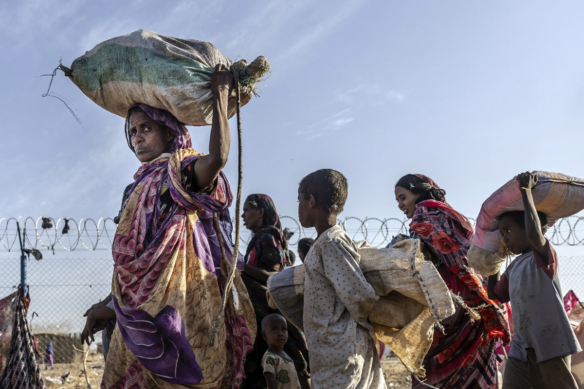 Sudanese refugees who have fled from the war in Sudan get off a truck loaded with families arriving at a Transit Centre for refugees in Renk, on February 13, 2024. More than 550,000 people have now fled from the war in Sudan to South Sudan since the conflict exploded in April 2023, according to the United Nations. (AFP/File)