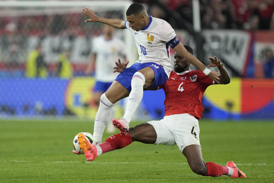 Austria’s Kevin Danso challenges Kylian Mbappe of France during their Group D match at the Euro 2024 tournament in Duesseldorf, on Jun. 17, 2024. (AP)
