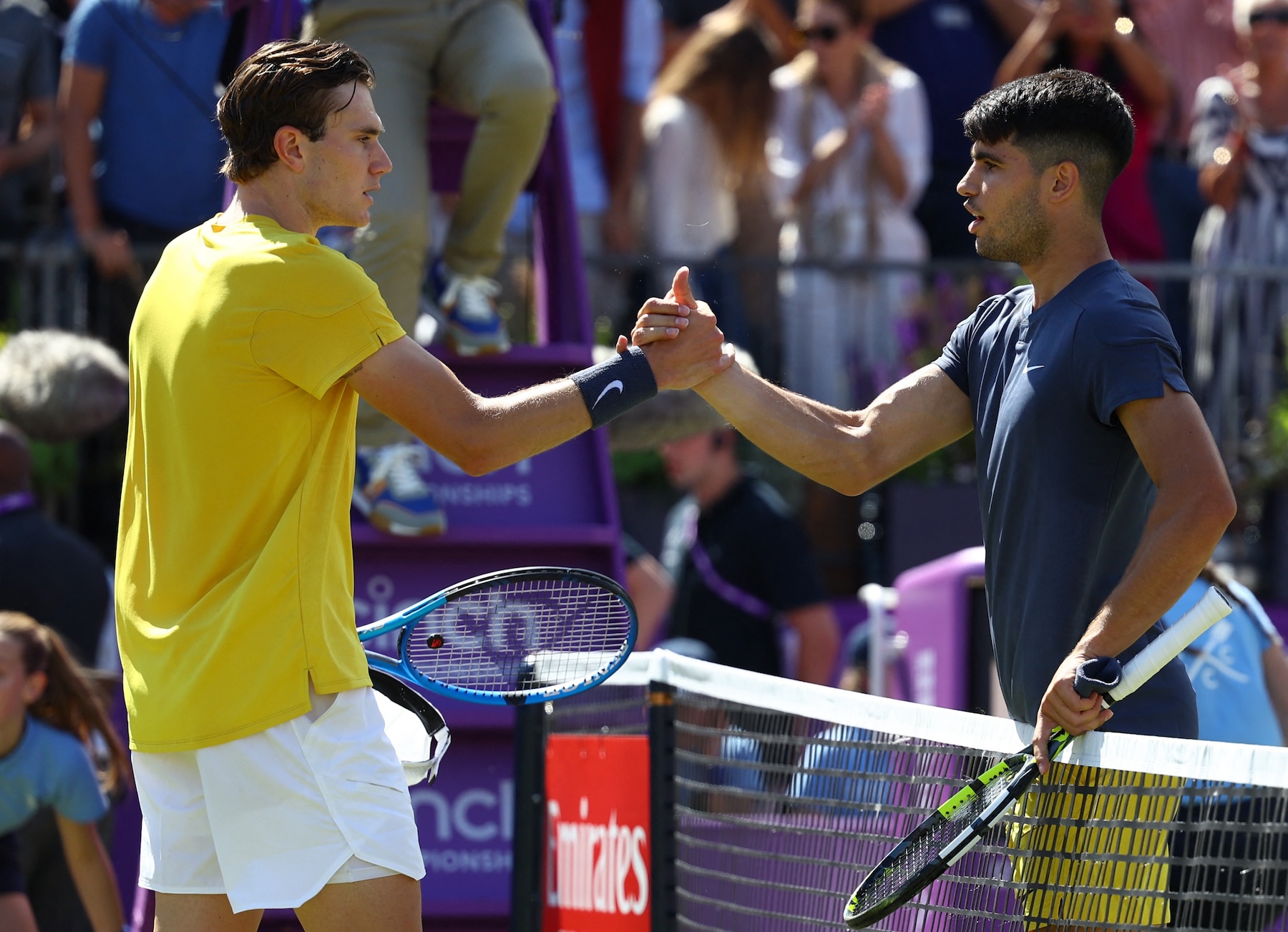 Britain's Jack Draper shakes hands with Spain's Carlos Alcaraz after winning their round of 16 match at the Queen’s Club Tournament in London Thursday. (REUTERS)