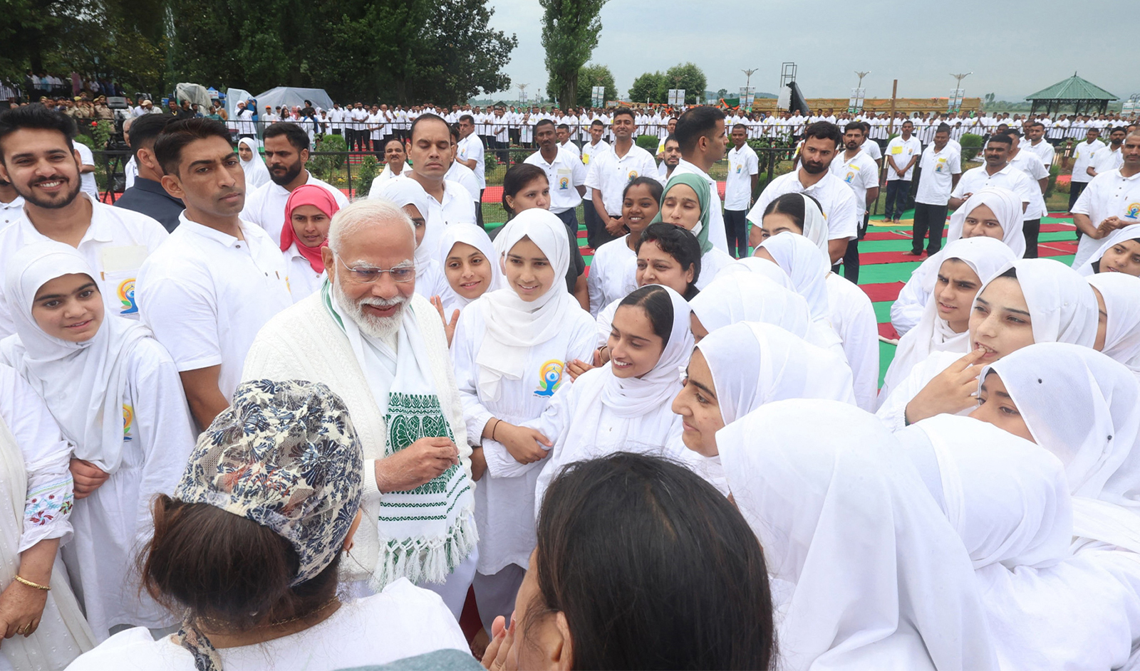 In this handout photograph taken and released on June 21, 2024 by the Indian Press Information Bureau (PIB), India's Prime Minister Narendra Modi talks to people on International Day of Yoga in Srinagar. (AFP/Indian Press Information Bureau)