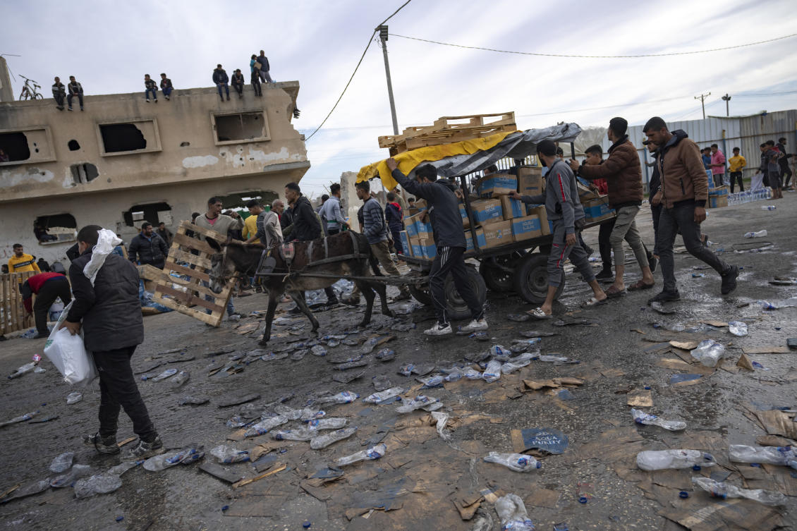 FILE — Palestinians loot a humanitarian aid truck as it crossed into the Gaza Strip in Rafah, Sunday, Dec. 17, 2023. A persistent breakdown in law and order is rendering an aid route in south Gaza unusable, the UN and NGOs say, days after Israel’s military said it would pause combat there to help aid reach desperate Palestinians. (AP)
