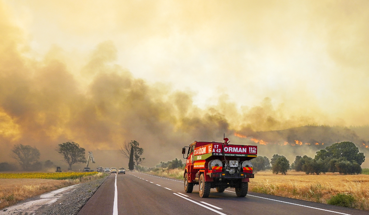 Firefighters work to extinguish a fire burning near Kumkoy in Gallipoli peninsula. (AP)