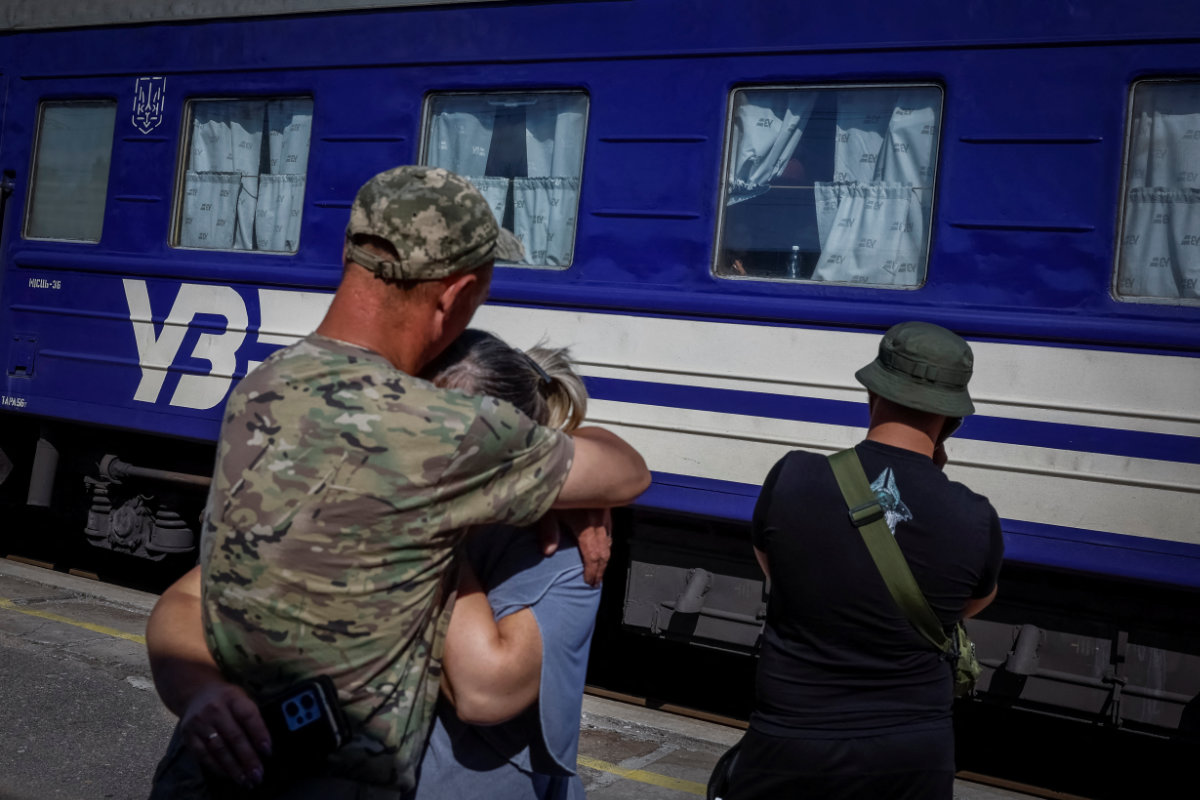 A Ukrainian soldier hugs a loved one who visited him during a short break from his frontline duty at the train station in Kramatorsk, Ukraine, on June 21, 2024. (REUTERS)