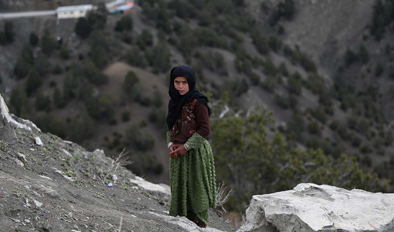 An Afghan girl stands along a hilltop in Sato kandaw area on the outskirts of Gardez, the capital of Paktia province on April 21, 2024. (AFP/File)
