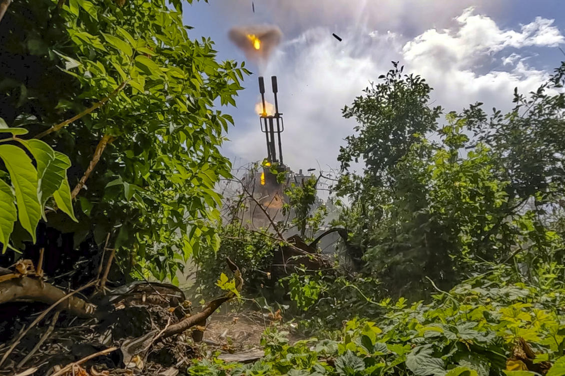 Above, Russian soldiers fire an anti-aircraft gun at an undisclosed location in Ukraine on June 21, 2024. (Russian Defense Ministry Press Service via AP)