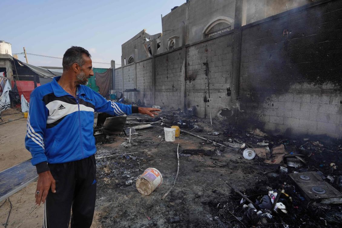 A Palestinian man points to ashes in a tented area, the day after a strike on the al-Mawasi area, northwest of the Palestinian city of Rafah on June 22, 2024, amid the ongoing conflict between Israel and the Palestinian Hamas militant group. (AFP)