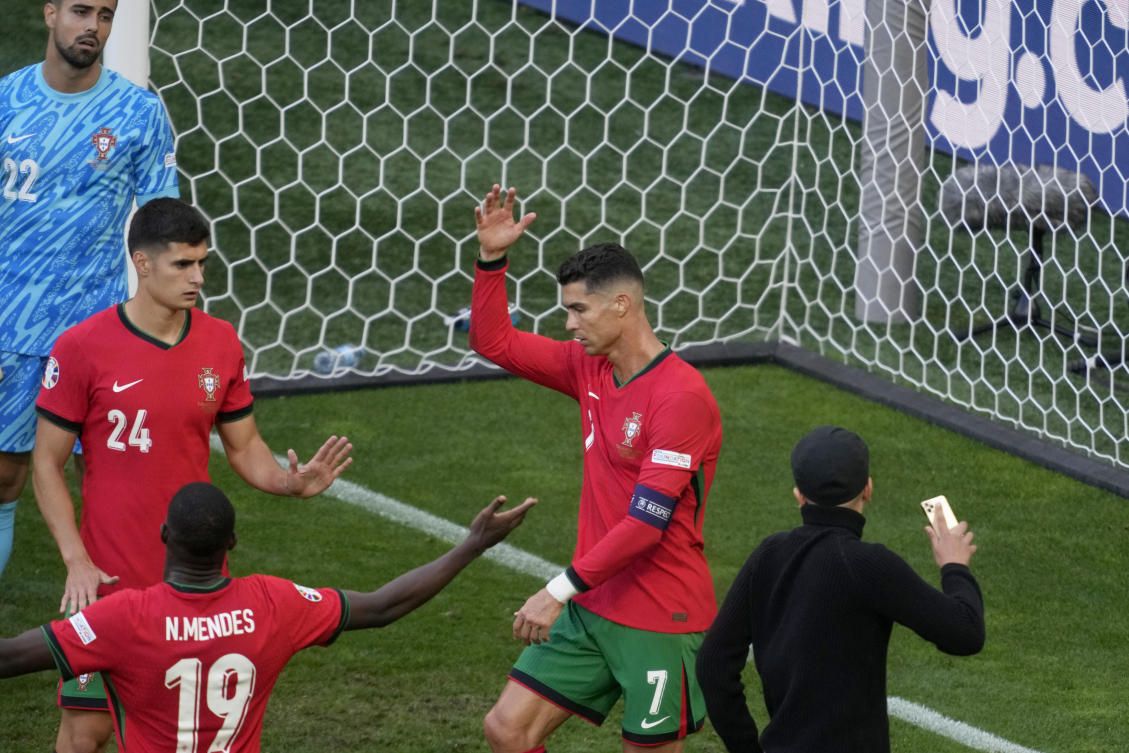 Four fans get on field for selfies with Cristiano Ronaldo during chaotic scenes at Euro 2024 match