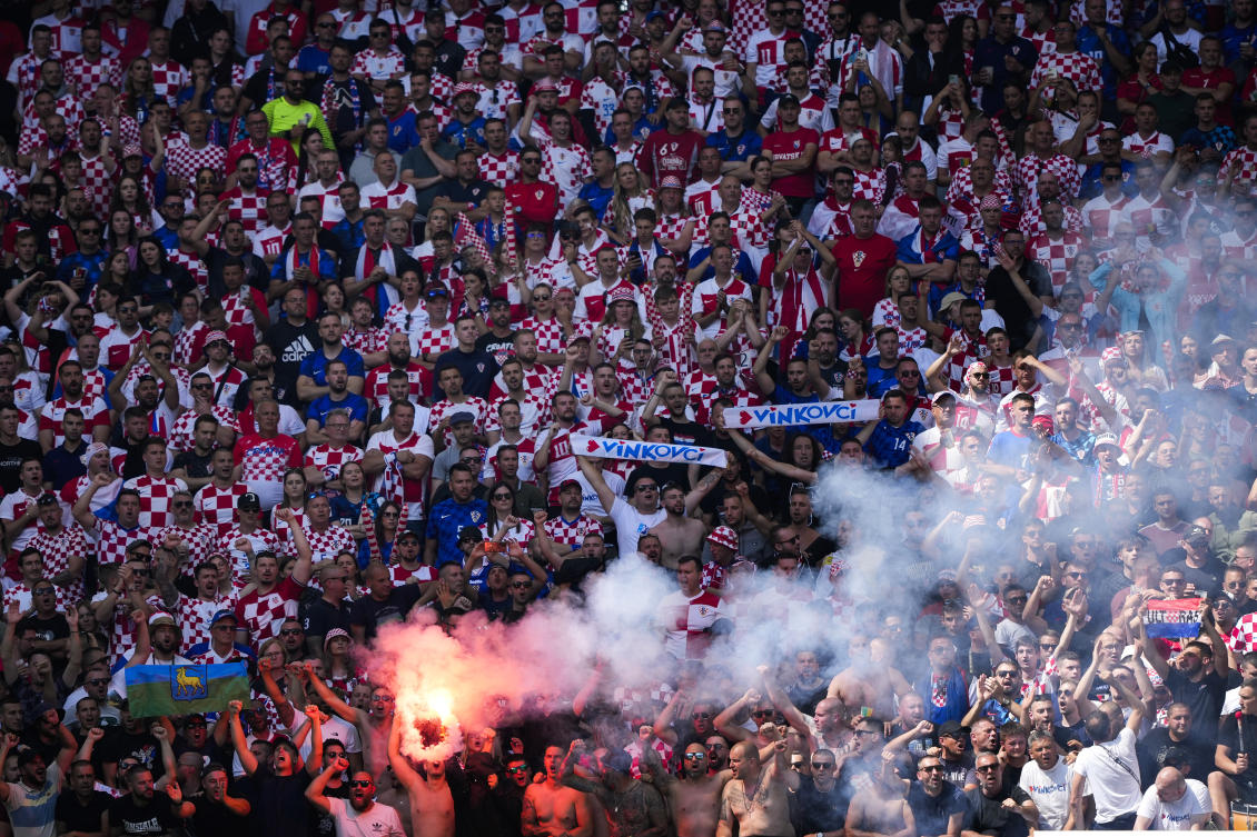 Croatian supporters light a flare as they cheer during a Group B match between Croatia and Albania at the Euro 2024 tournament in Hamburg, Germany, on Jun. 19, 2024. (AP)