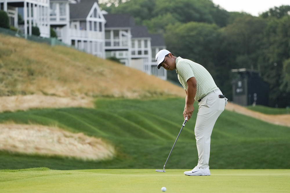 Tom Kim putts on the 12th green during the third round of the Travelers Championship golf tournament at TPC River Highlands, Saturday in Cromwell, Conn. (AP)