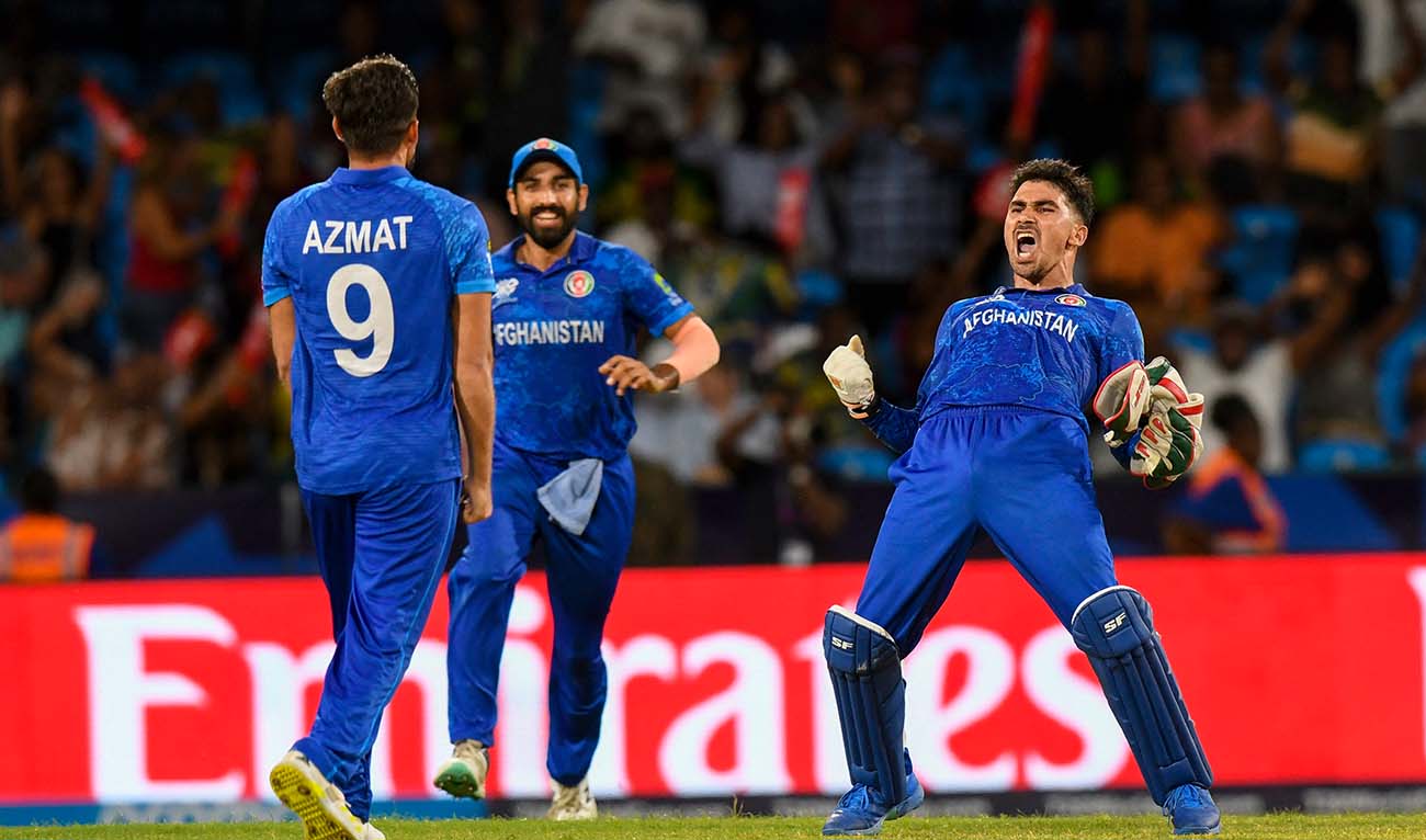 Afghanistan's Rahmanullah Gurbaz (R) celebrate his team's win of the ICC men's Twenty20 World Cup 2024 Super Eight cricket match between Afghanistan and Australia at Arnos Vale Stadium in Arnos Vale, Saint Vincent and the Grenadines on June 22, 2024. (AFP)