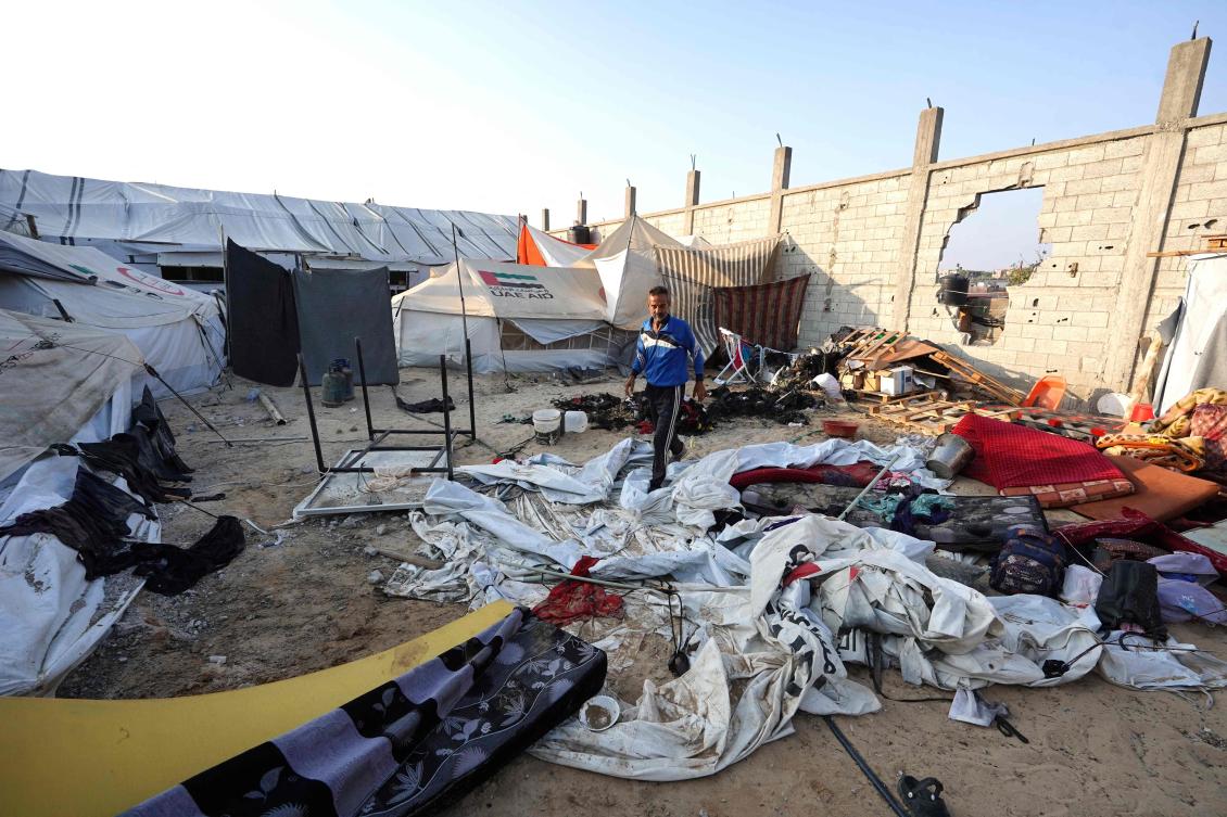 Above, a man walks across fallen tents the day after a strike on the Al-Mawasi area, northwest of the Palestinian city of Rafah on June 22, 2024. (AFP)