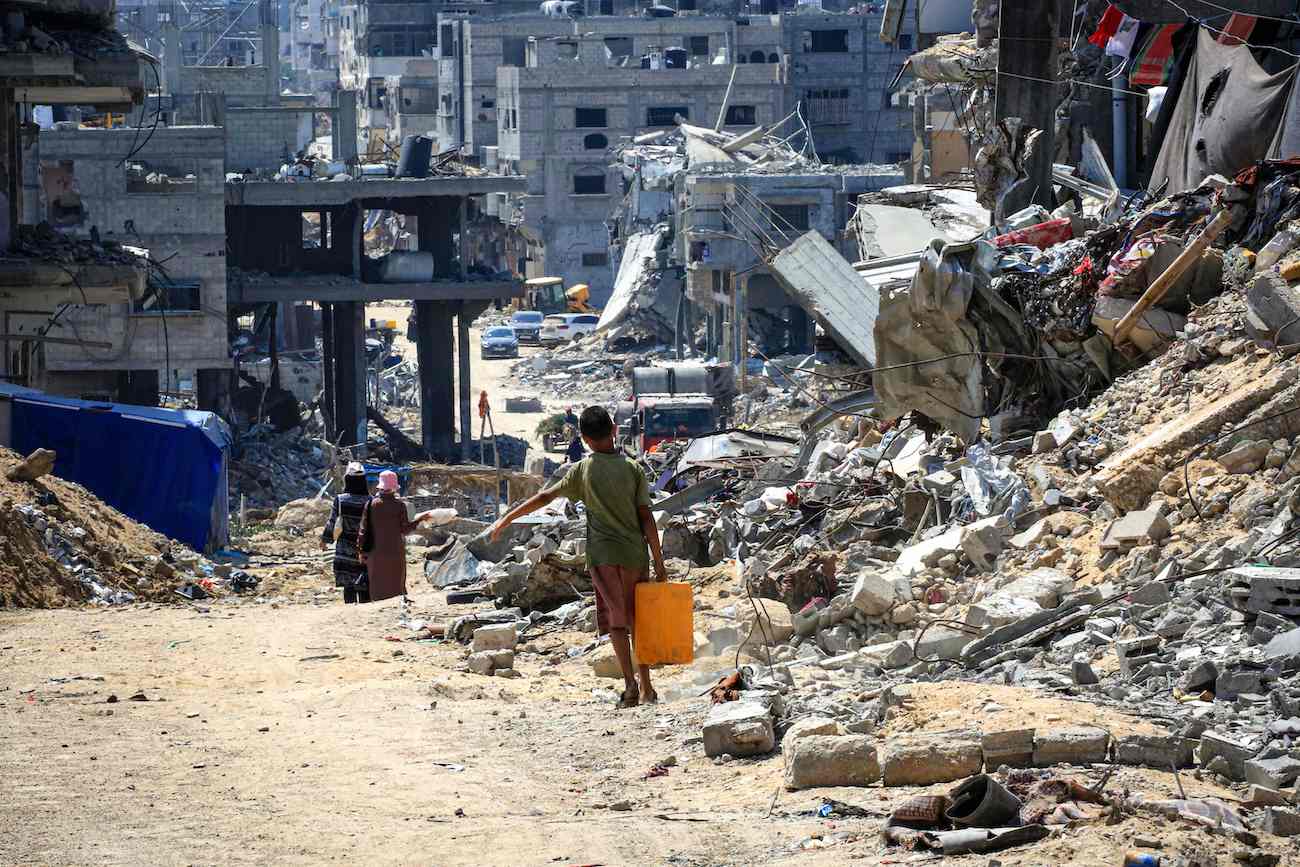 A youth carries water in Khan Yunis on the southern Gaza Strip on June 23, 2024. (AFP)