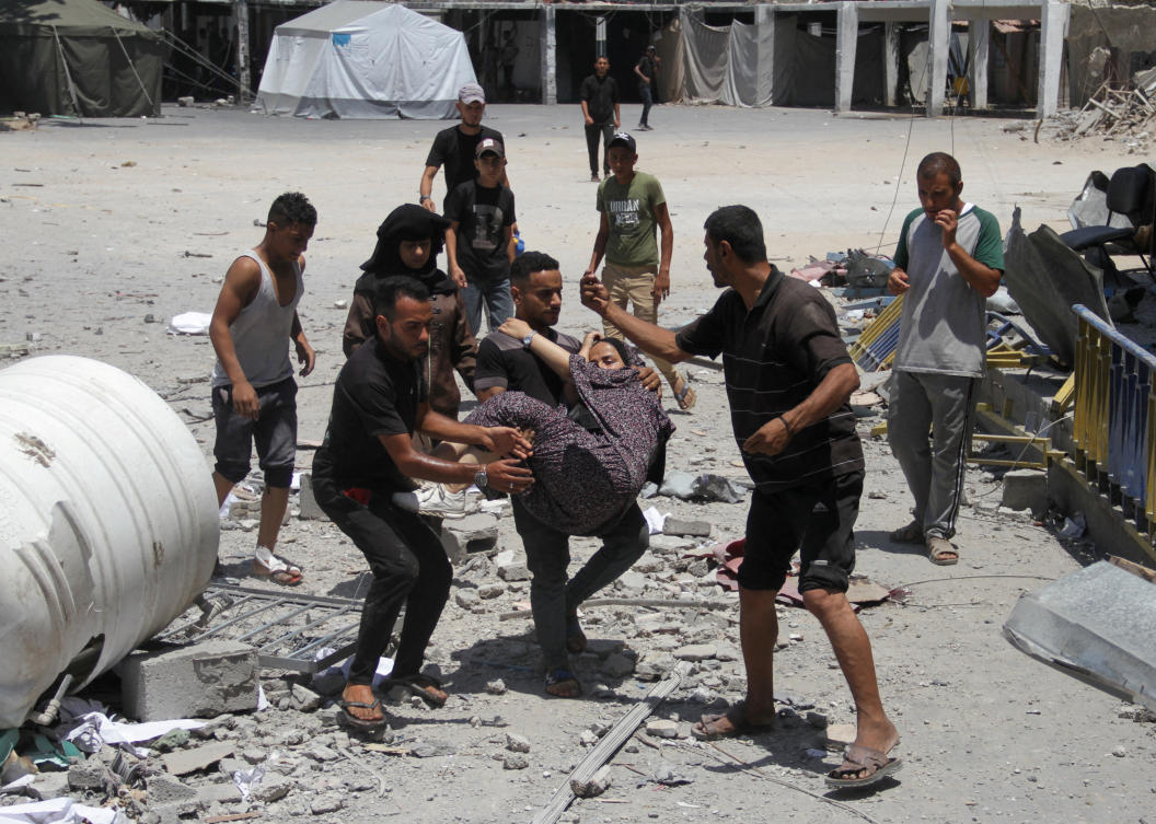 Palestinians carry a casualty outside the headquarters of UNRWA following an Israeli strike, amid the Israel-Hamas conflict, in Gaza City, June 23, 2024. (Reuters)
