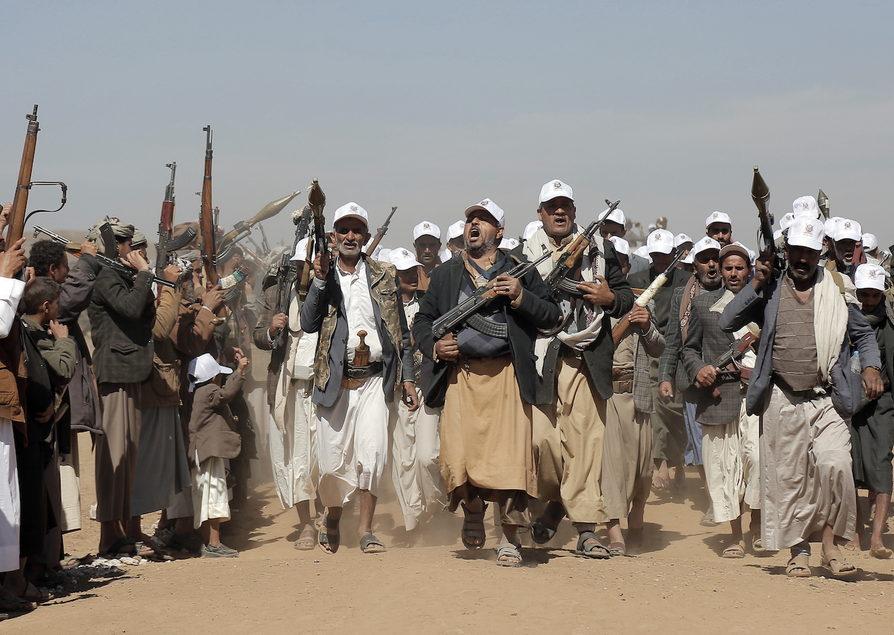 Houthi fighters march during a rally of support for the Palestinians in the Gaza Strip and against the US strikes on Yemen outside Sanaa on Jan. 22, 2024. (AFP)