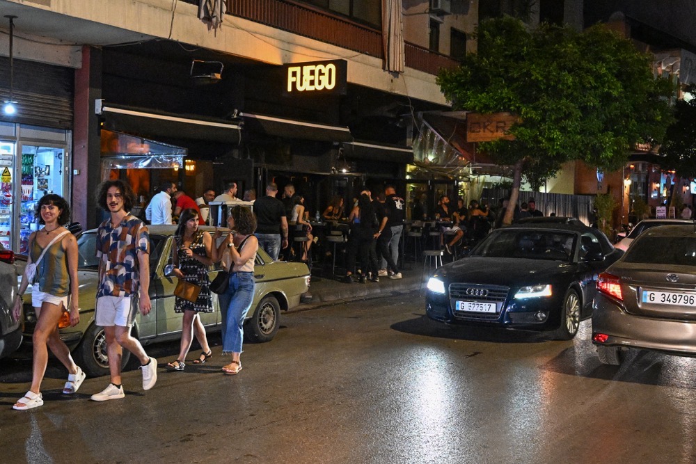 Revelers drink at a pub on a busy nightlife street in Beirut's Mar Mikhail neighbourhood on June 22, 2024. (AFP)