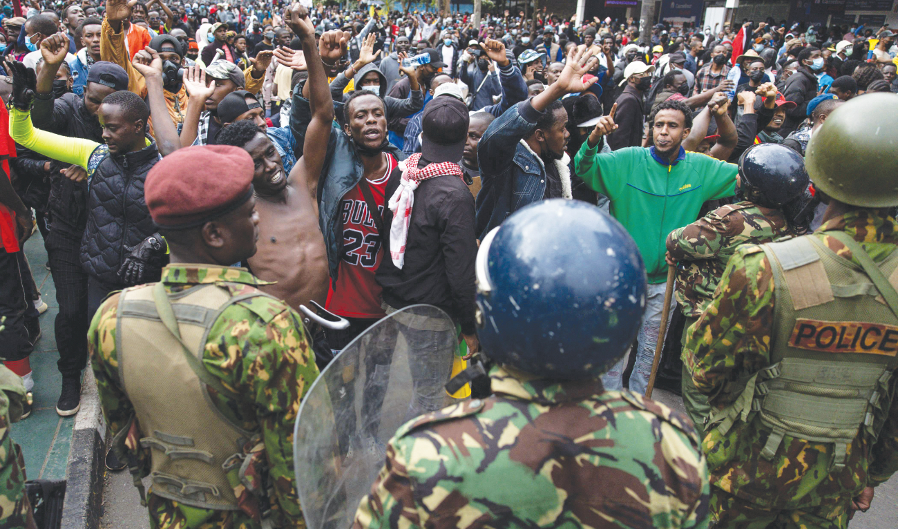 Demonstrators took to the streets across Kenya on Friday to protest contentious tax hikes. Police fired tear gas to disperse protesters near parliament. (AFP)