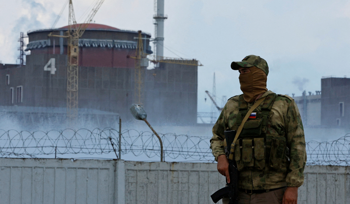 A serviceman with a Russian flag on his uniform stands guard near the Zaporizhzhia Nuclear Power Plant in the course of Ukraine-Russia conflict outside the Russian-controlled city of Enerhodar in the Zaporizhzhia region, Ukraine August 4, 2022. (REUTERS)