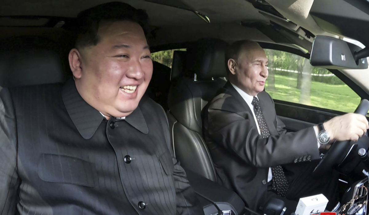 In this photo provided by the North Korean government, Russia's President Vladimir Putin, right, drives a car with North Korean leader Kim Jong Un sitting in front passenger seat at a garden of the Kumsusan State Guest House in Pyongyang, North Korea Wednesday, June 19, 2024. (AP)