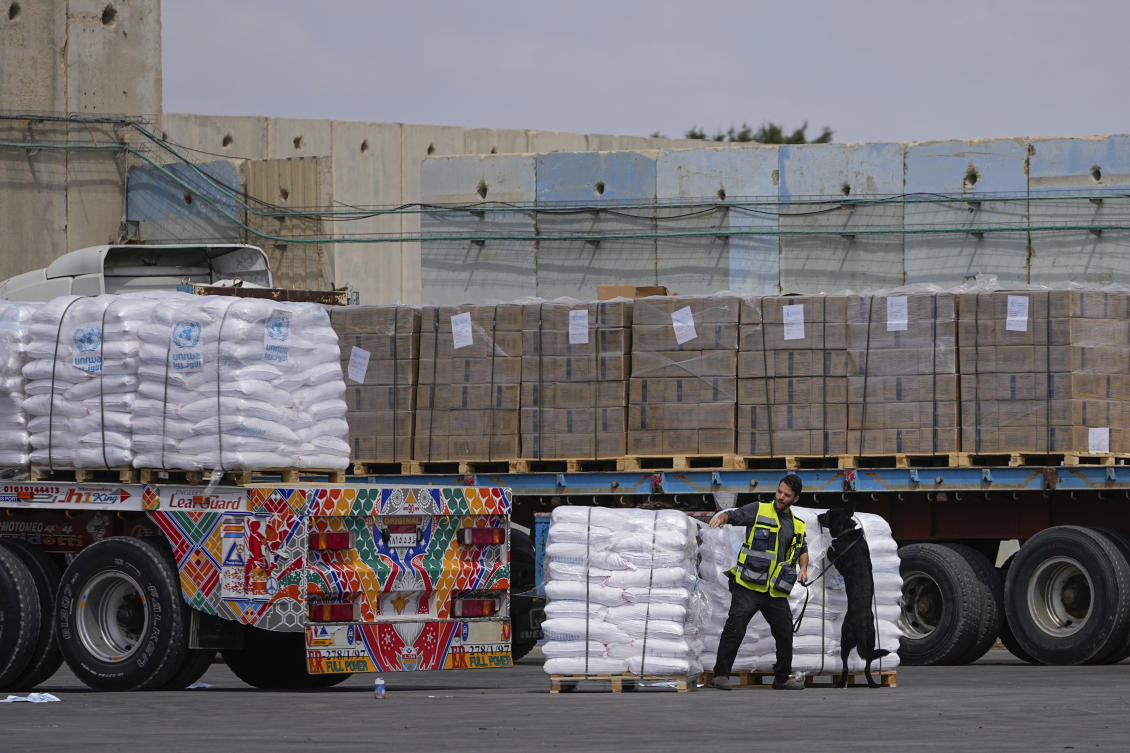 Trucks carrying humanitarian aid for the Gaza Strip pass through the inspection area at the Kerem Shalom Crossing in southern Israel. (File/AP)