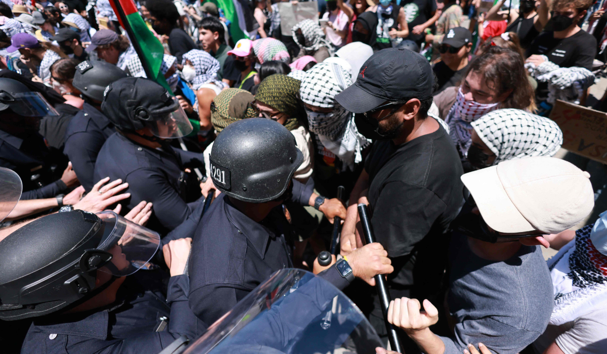Los Angeles Police Department (LAPD) officers clash with anti-Israel protesters gathered outside the Adas Torah Orthodox Jewish synagogue, preventing access to an event on real estate investment in Israel, in Los Angeles, June 23, 2024. (AFP)