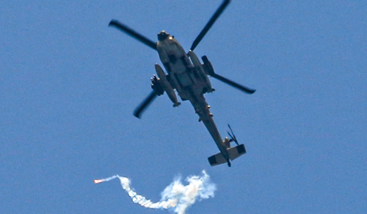 An Israeli air force attack helicopter releases flares while flying over northwest of Rafah in the southern Gaza Strip on June 24, 2024 amid the ongoing conflict in the Palestinian territory between Israel and Hamas. (AFP)