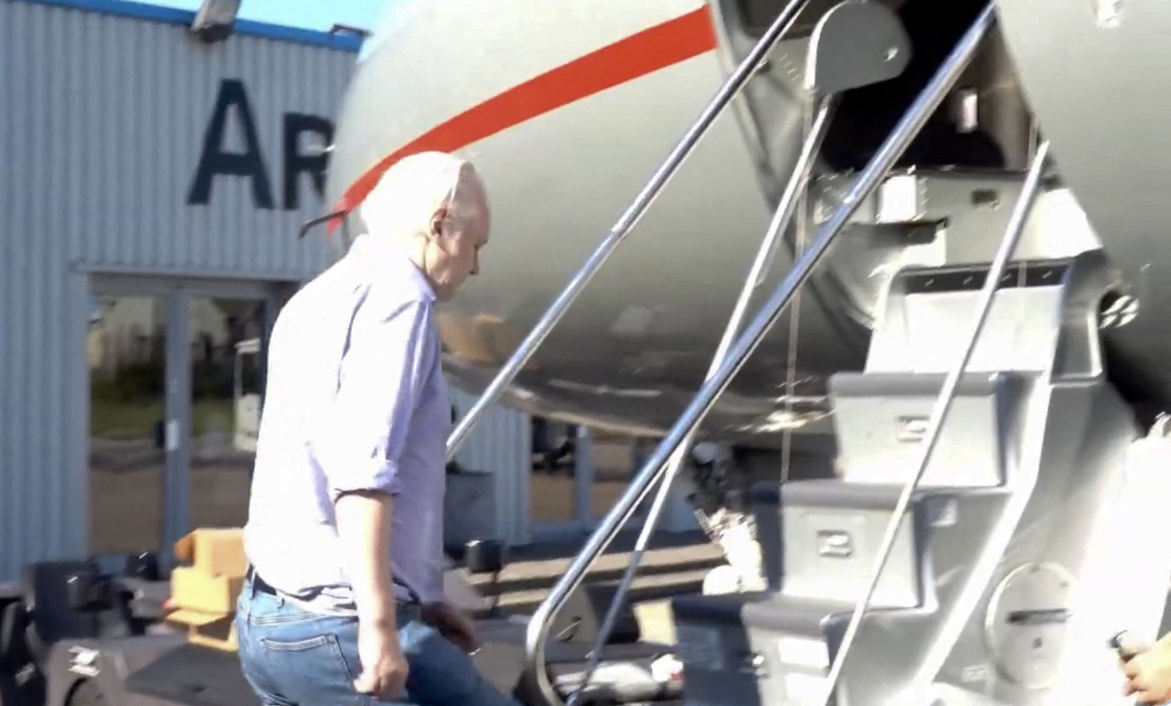 This screen shot courtesy of Wikileaks X page shows Wikileaks founder Julian Assange walking to board a plane from London Stansted Airport on June 24, 2024. (AFP)