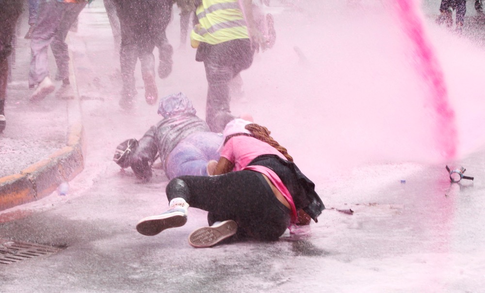 People fall as they run after police use water cannon to disperse protesters during a demonstration against Kenya's proposed finance bill 2024/2025 in Nairobi, Kenya. (Reuters)