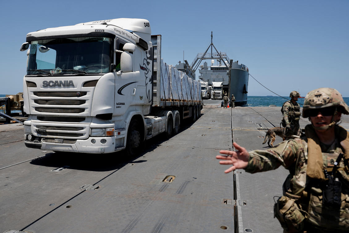 A truck carries humanitarian aid across Trident Pier, a temporary pier to deliver aid, off the Gaza Strip, near the Gaza coast, on Jun. 25, 2024. (Reuters)