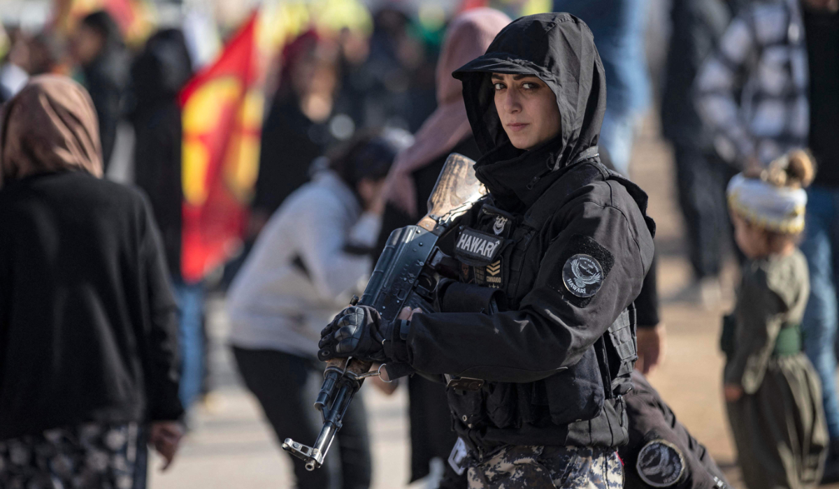 A female member of the Syrian Kurdish Asayish security forces stands guard in Qamishli in northeastern Syria. (AFP)