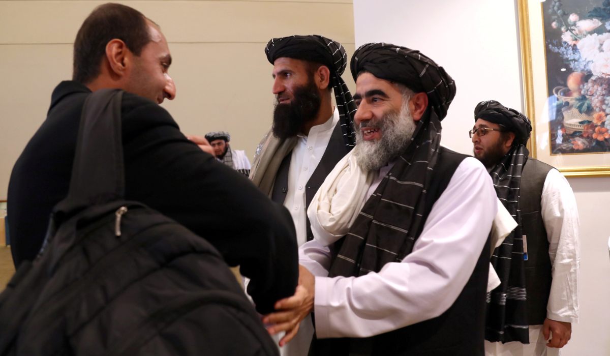 Members of Afghanistan's Taliban delegation (R) gather ahead of an agreement signing between them and US officials in Doha, Qatar, February 29, 2020. (REUTERS)
