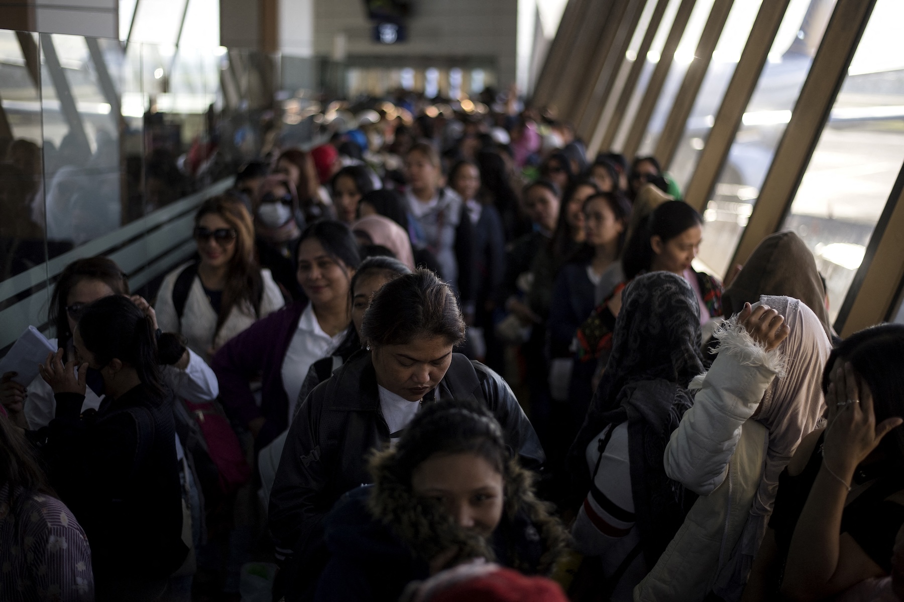 Filipino workers returning home from Kuwait arrive at Manila International Airport. (AFP/File)