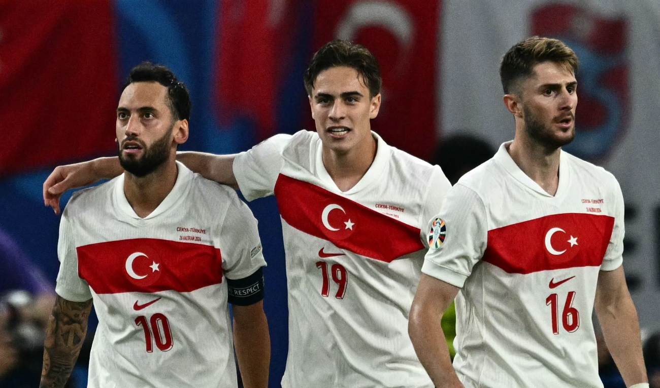 Turkiye’s midfielder #10 Hakan Calhanoglu (L) celebrates scoring his team’s first goal with forward #19 Kenan Yildiz and midfielder #16 Ismail Yuksek during the UEFA Euro 2024 Group F football match between against the Czech Republic at the Volksparkstadion in Hamburg on June 26, 2024. (AFP)