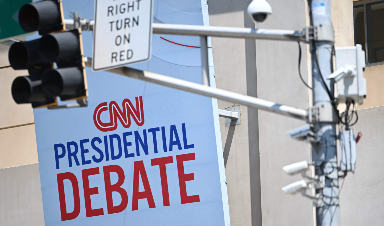 CNN signage near a traffic light with security cameras on it is displayed outside the studios at the Turner Entertainment Networks as Atlanta prepares one day ahead of the first 2024 presidential debate between US President Joe Biden and former President Donald Trump, on June 26, 2024. (AFP)