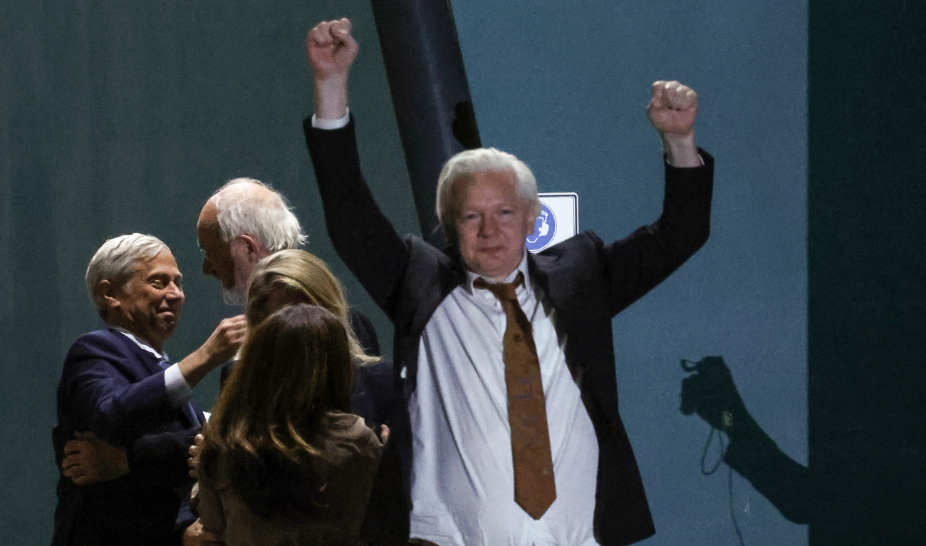 WikiLeaks founder Julian Assange (C) celebrates after arriving at Canberra Airport in Canberra on June 26, 2024. (AFP)