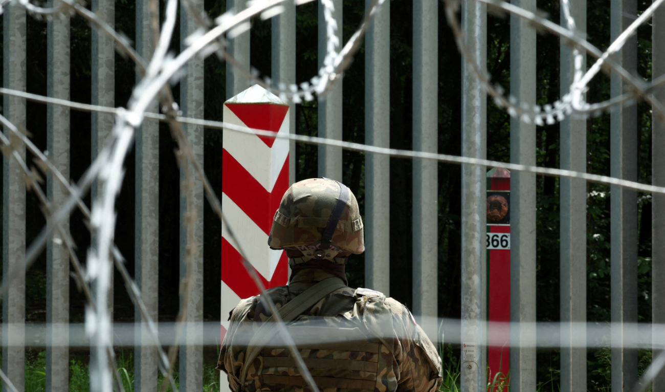 A soldier stands guard near the fence on the Belarusian-Polish border in the forest near Bialowieza, Poland, June 4, 2024. (Reuters/File)