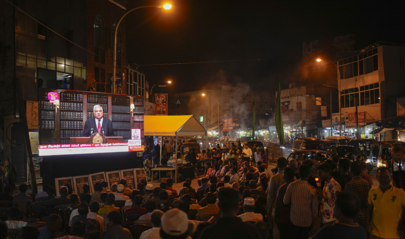 Supporters of Sri Lanka’s President Ranil Wickremesinghe watch a televised speech in Colombo, Sri Lanka, Wednesday, June 26, 2024. (AP)
