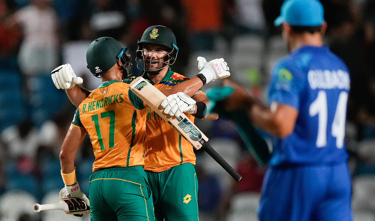 South Africa’s Reeza Hendricks, left, embraces teammate Aiden Markram after defeating Afghanistan in their men’s T20 World Cup semifinal cricket match at the Brian Lara Cricket Academy in Tarouba, Trinidad and Tabago on June 26, 2024. (AP)