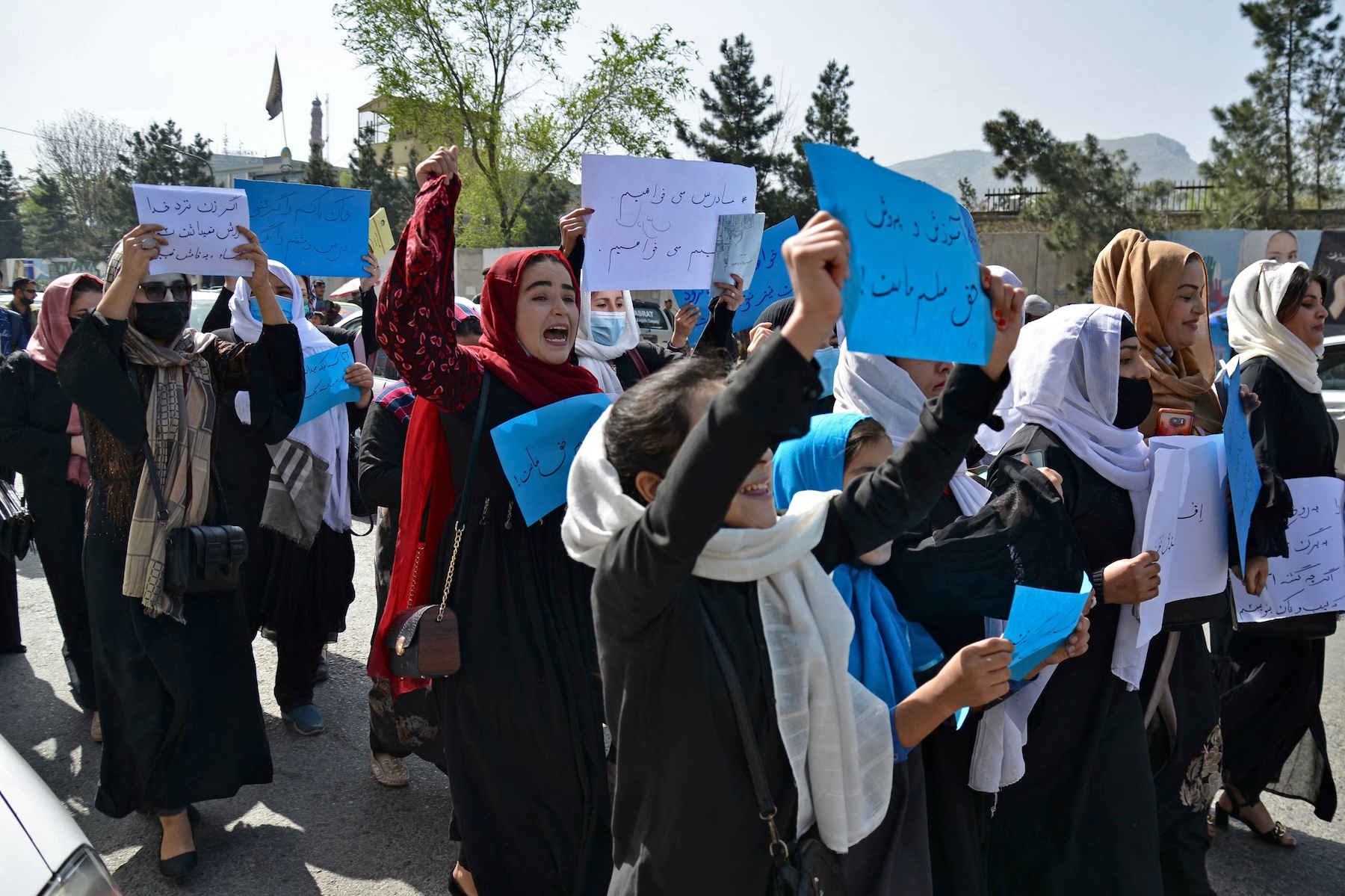 Afghan women and girls take part in a protest in front of the Ministry of Education in Kabul on March 26, 2022, demanding that high schools be reopened for girls. (AFP/File)