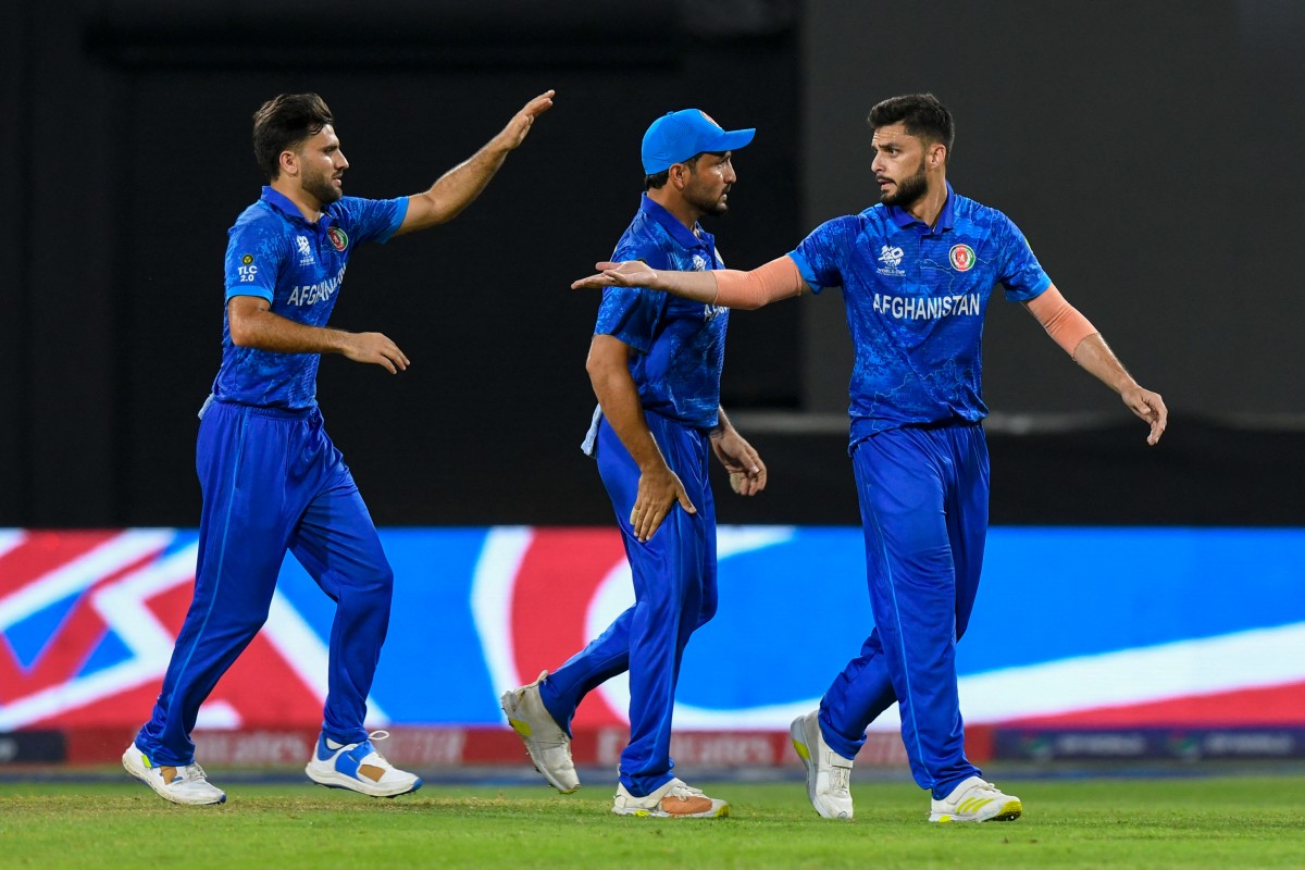 Afghanistan's Naveen-ul-Haq (R) and Afghanistan's Fazalhaq Farooqi (L) celebrate the dismissal of Bangladesh's captain Najmul Hossain Shanto during the ICC men's Twenty20 World Cup 2024 Super Eight cricket match between Afghanistan and Bangladesh at Arnos Vale Stadium in Arnos Vale, Saint Vincent and the Grenadines on June 24, 2024 (AFP)