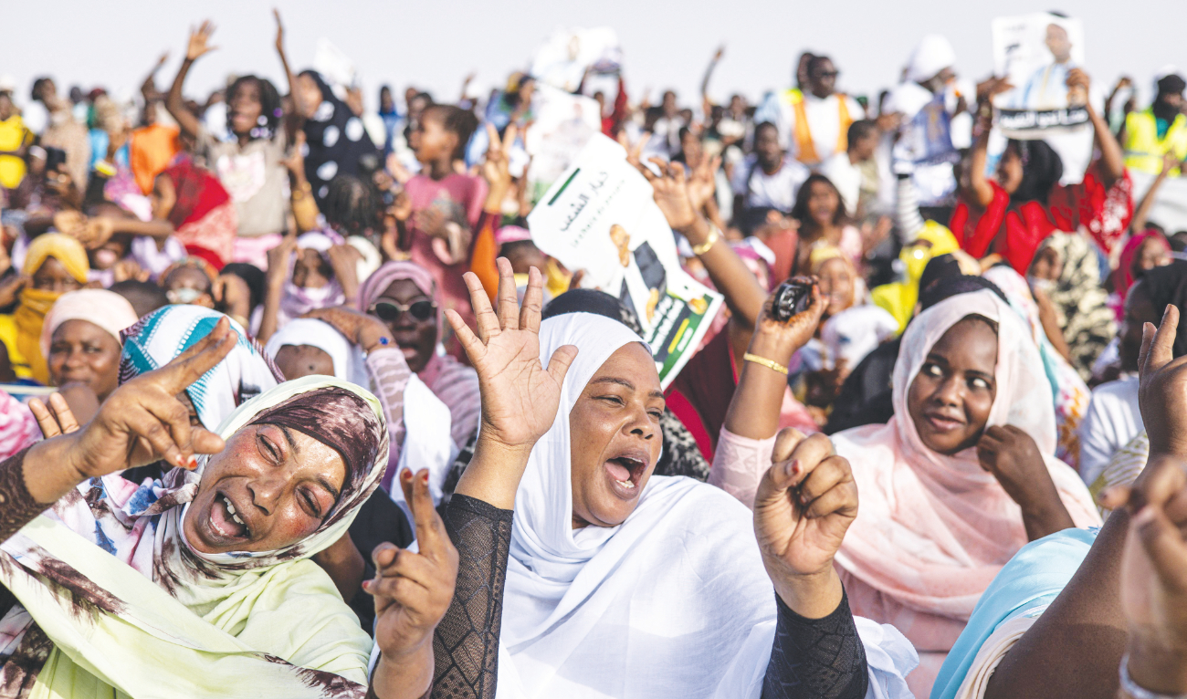 People sing and dance during a presidential campaign rally in Nouakchott. The incumbent president is expected to win a second term in Saturday’s poll. (AFP)