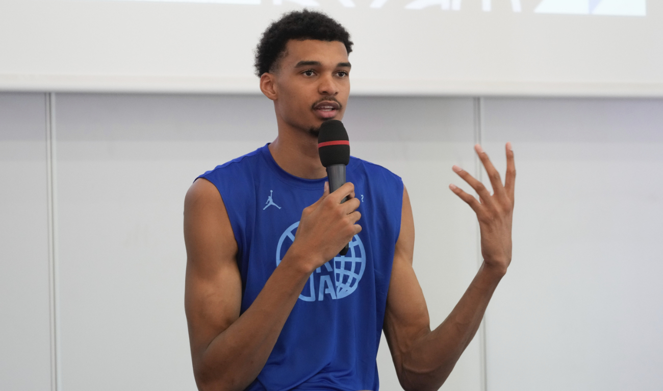 France's basketball star Victor Wembanyama, who plays for the NBA San Antonio Spurs, gestures while speaking during media day at the French National Institute of Sport and Physical Education, in Vincennes, outside Paris, Thursday. (AP)