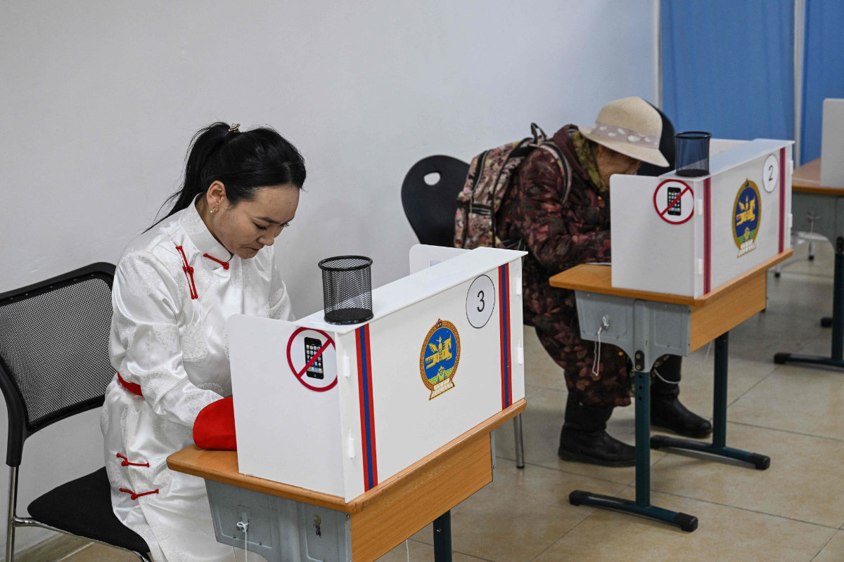 People vote in the Mongolian parliamentary elections at a polling station in Nalayh on the outskirts of Ulaanbaatar on June 28, 2024. (AFP)