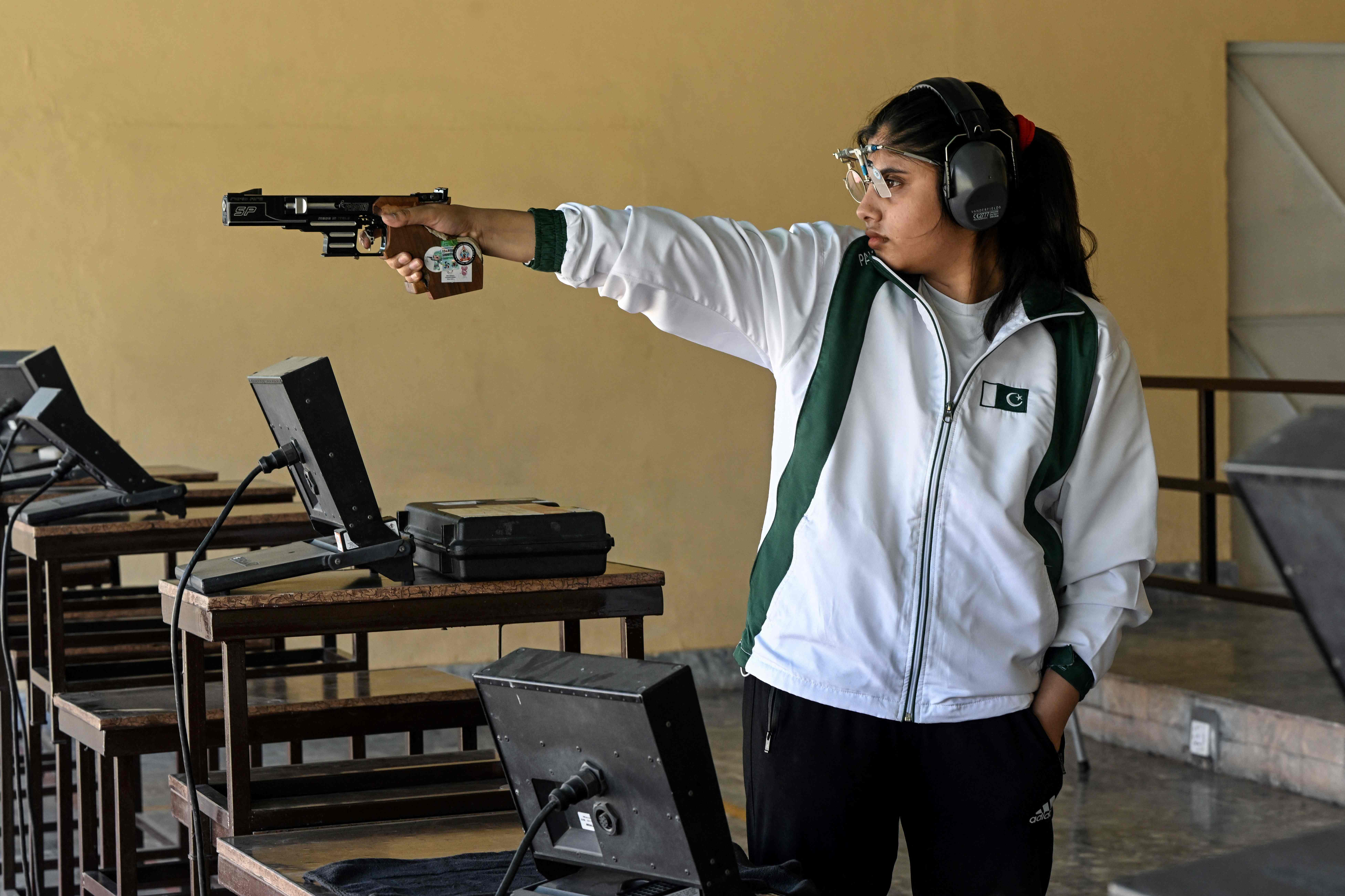 In this photograph taken on May 21, 2024 Kishmala Talat, Pakistan's first female to qualify for Olympic shooting, aims an air pistol at a 25m target range during a practice session at the Army Marksmanship Unit (AMU) in Jhelum. (AFP)