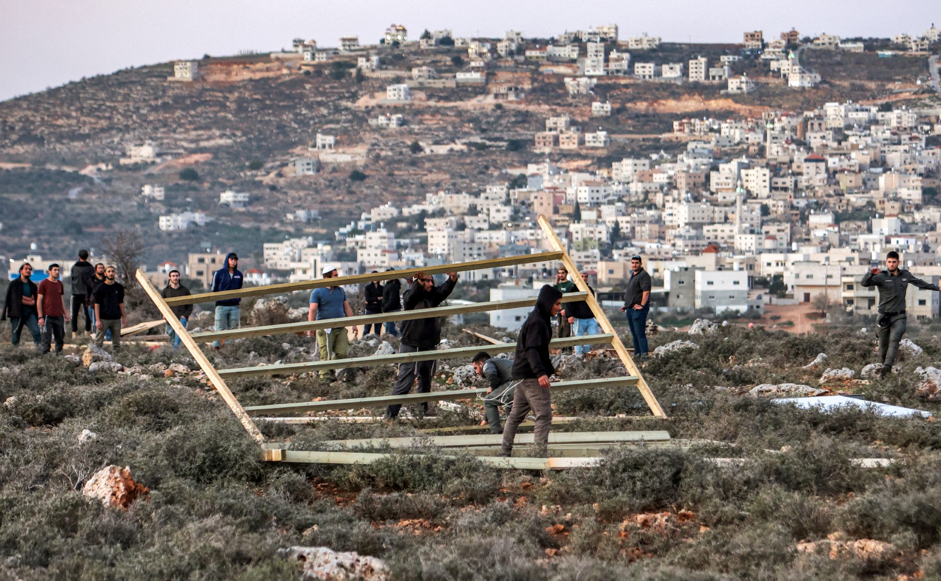 File of photo Israeli border guards remove a structure erected by settlers attempting to reestablish an illegal settlement outpost called Or Haim, near the settelment of Migdalim, in the north of occupied West Bank on January 22, 2023 (AFP)